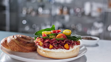 cheff adding pepper to bacon sandwich