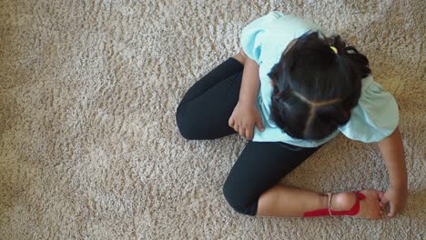 child sitting on carpet