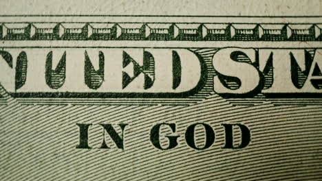 close-up of us dollar bill with "in god we trust"