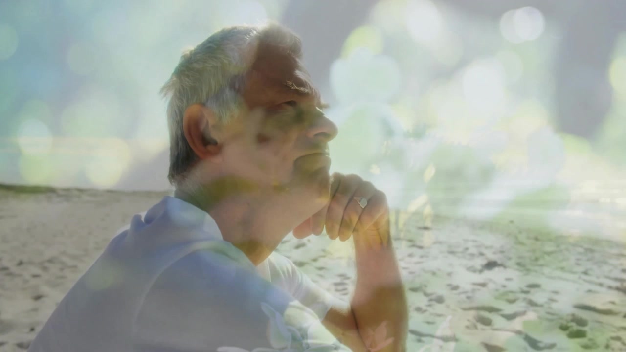 Senior Man Reflecting on Beach with Double Exposure Nature Overlay