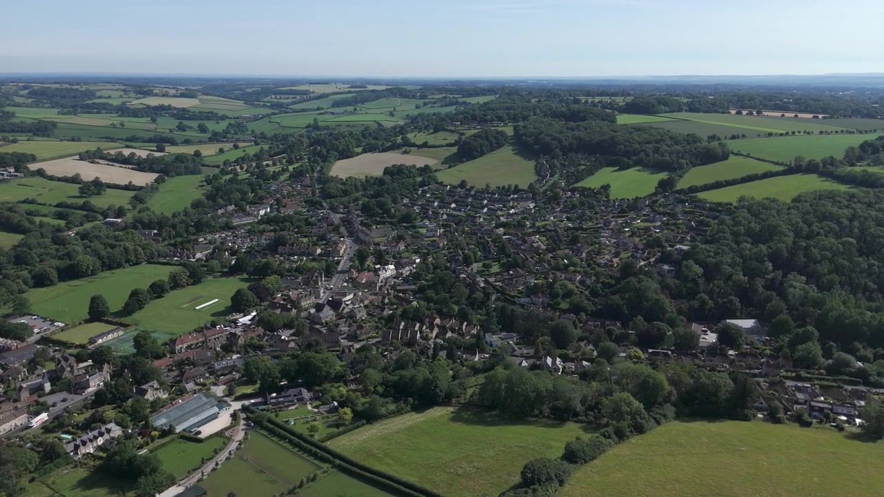 Aerial pan L to R Box from Ashley, Wiltshire on a summers day