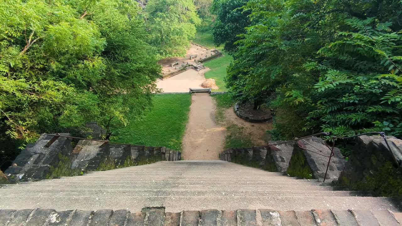 View from top of steep stone stairway steps of ancient Yapahuwa Rock Fortress palace in Sri Lanka