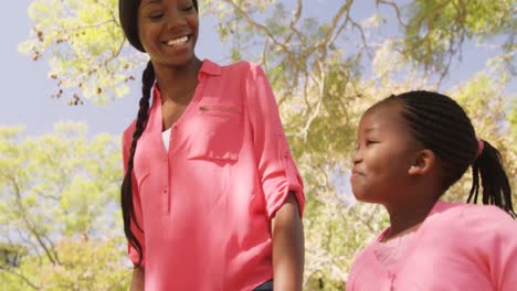 mother and daughter is walking and holding by hand