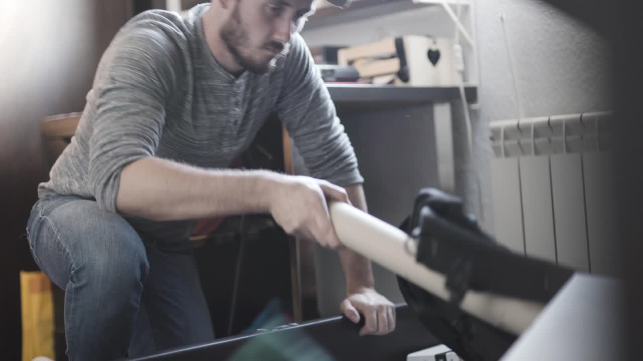 Man organizing his storage bed at home