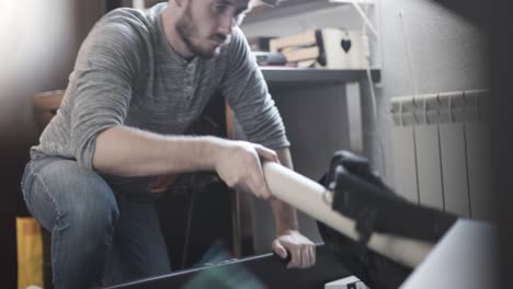 Man-organizing-his-storage-bed-at-home