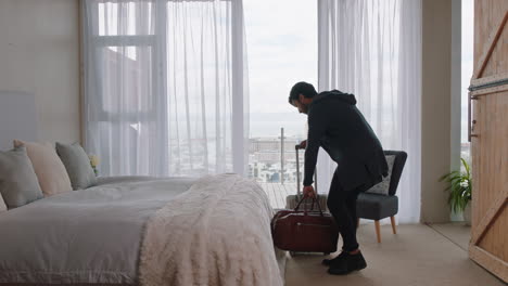 happy young man jumping on bed resting after successful travel journey enjoying independent lifestyle freedom