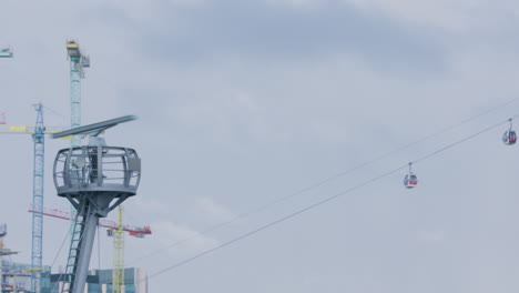 cable cars traveling over river thames in london