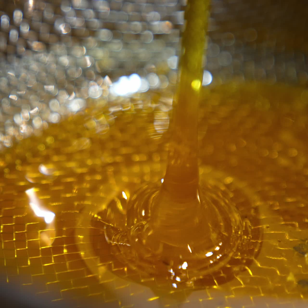 Sweet honey pouring close up view. Fresh natural honey flowing
