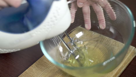 beating eggs with electric mixer. cake ingredients. food prepare. baking tools