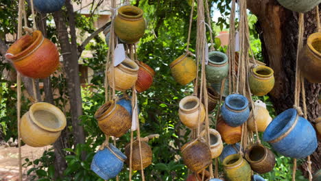 Close-up-of-hand-painted-assorted-small-jars-on-display-hanging-on-strings-in-a-store-in-Tubac,-Arizona