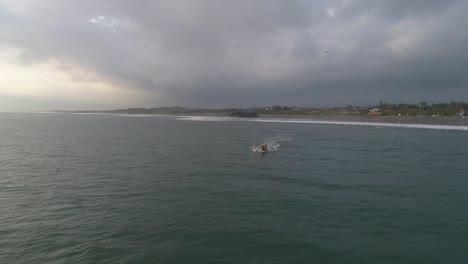 fishing canoe leaving indonesian shore