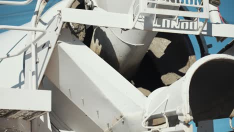 close up of concrete mixing truck mixing concrete