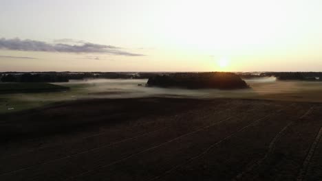 Flight-above-sunset-fog-in-golden-hour-after-rain