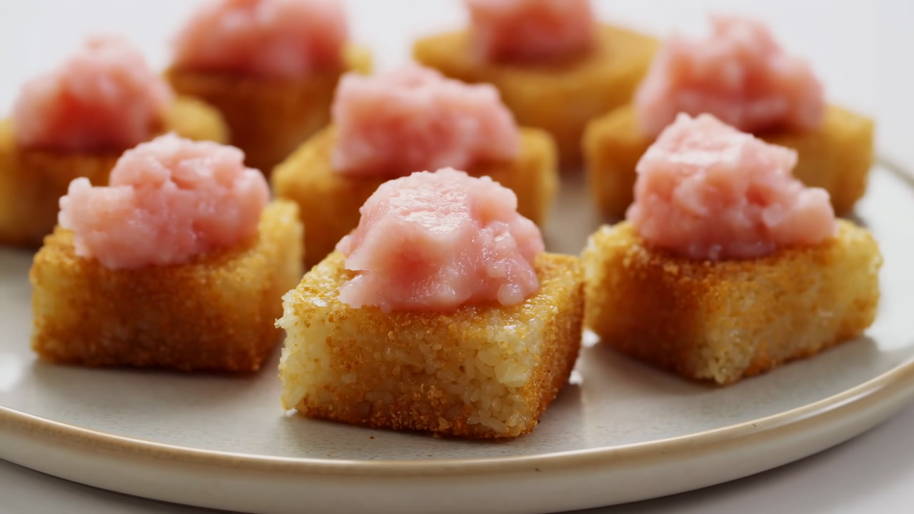 Closeup Plate Of Salmon Canaps Showcasing Polenta Toasts Topped With Pink Mousse, Golden Edges And Creamy