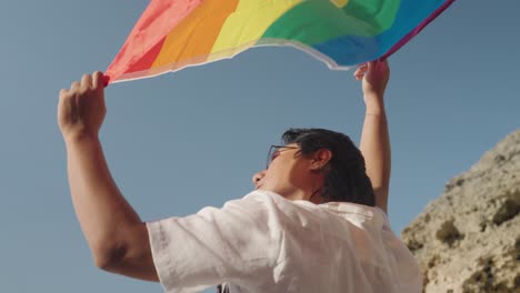 person holding a rainbow pride flag