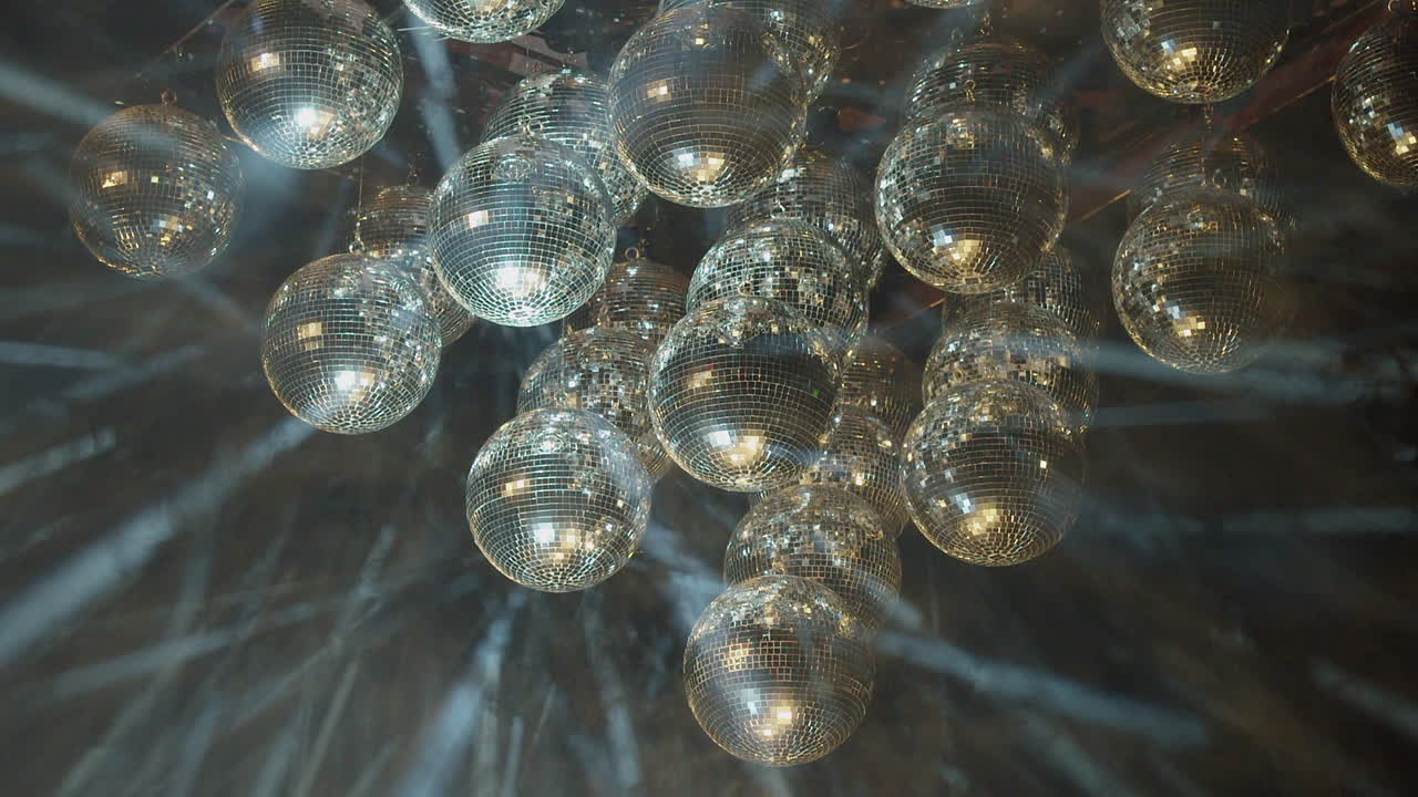 espectáculo de luz láser nebuloso con bolas de discoteca de espejo en la oscuridad nebulosa