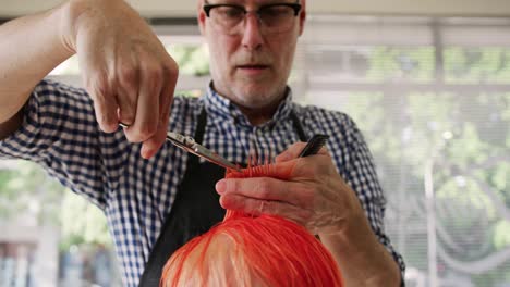 front view hairdresser cutting woman hair