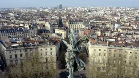 angel of liberty girondins monument with towering column erected to honor girondin revolutionaries, bordeaux, france, aerial dolly-out reveal shot