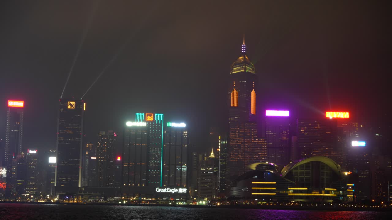 Hong Kong city skyline at night illuminated with neon lights and lasers