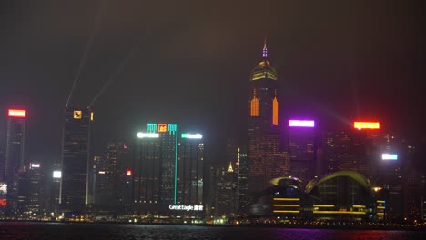 hong kong city skyline at night illuminated with neon lights and lasers