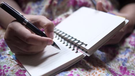 woman writing in notebook