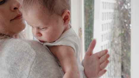 mother holding baby calming her newborn child mom gently soothing infant enjoying nurturing motherhood at home 4k