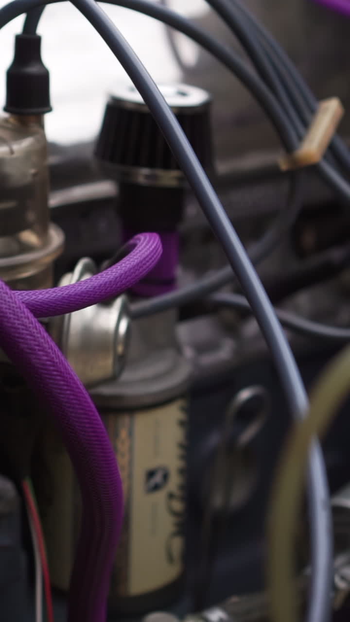 Close-up of a car engine compartment with purple wires