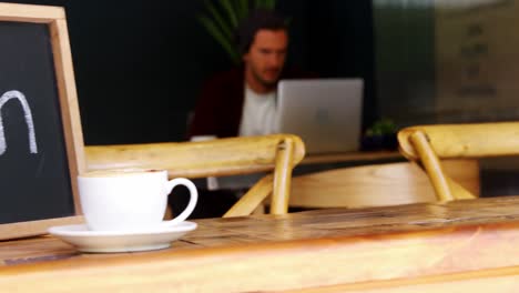 tablero abierto con una taza de café en la mesa