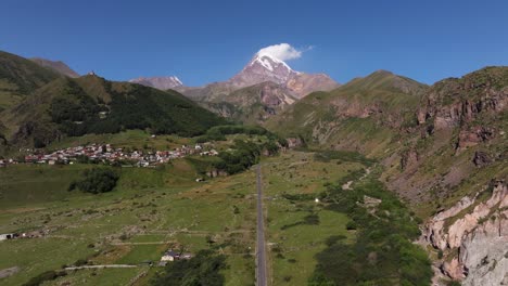 aerial establishing shot above road to mount kazbek, georgia