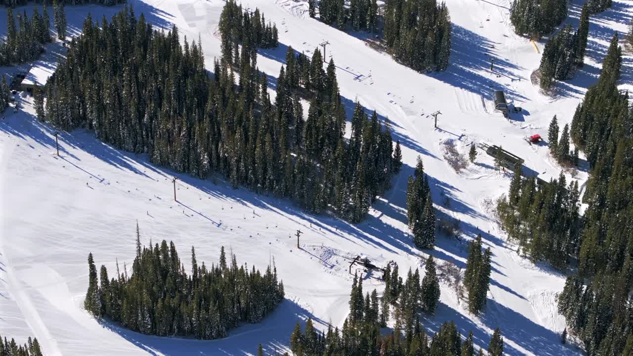 Birdseye view unique perspective Winter Park Ski Resort Colorado aerial drone skiers snowboarders gondola chairlift sunny groomers ski trails snowboarding runs December morning base area circle right