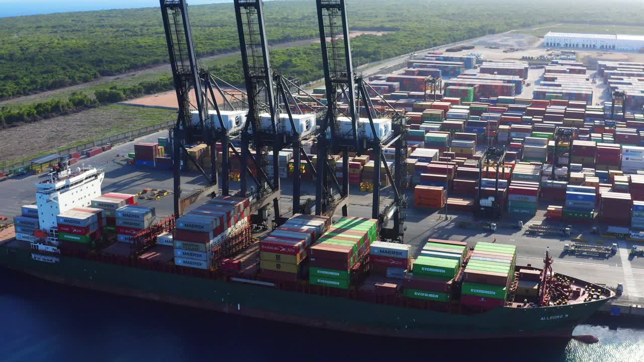 Aerial orbit over cargo ship and cranes at Caucedo port, Dominican Republic