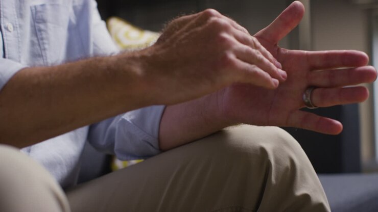 Close Up Of Expressive Hands Of Man In Conversation With Counsellor Doctor Or Other Person