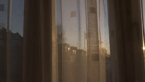 yellow orange sunset sunbeam reveal through curtains