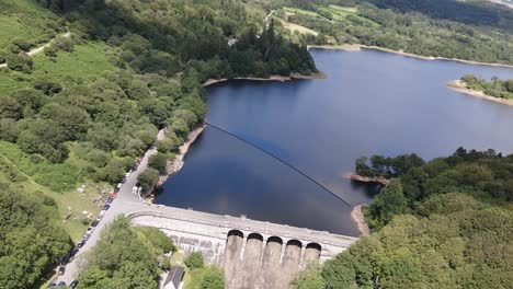 slow aerial rolling pull back of burrator reservoir dam, dartmoor national park