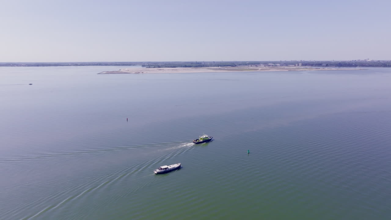 Stunning drone footage captures a Luxemotor vessel navigating serenely under a clear blue sky in Holland