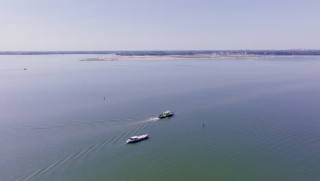 Stunning drone footage captures a Luxemotor vessel navigating serenely under a clear blue sky in Holland