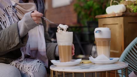 woman enjoying a latte in an outdoor cafe