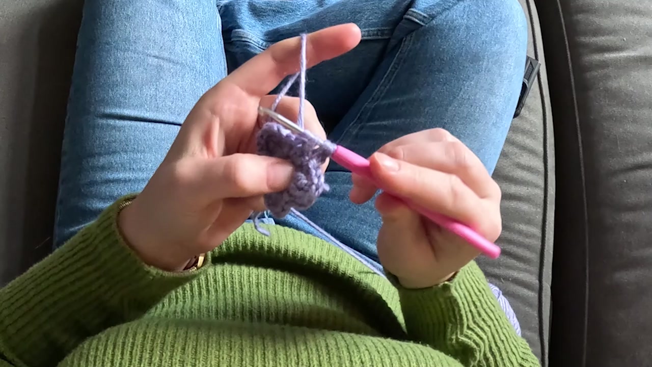 Video of a woman's POV knitting.