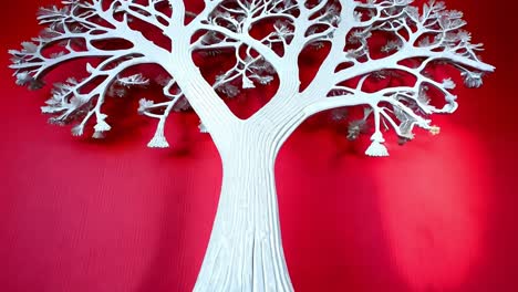 white paper tree sculpture on red background