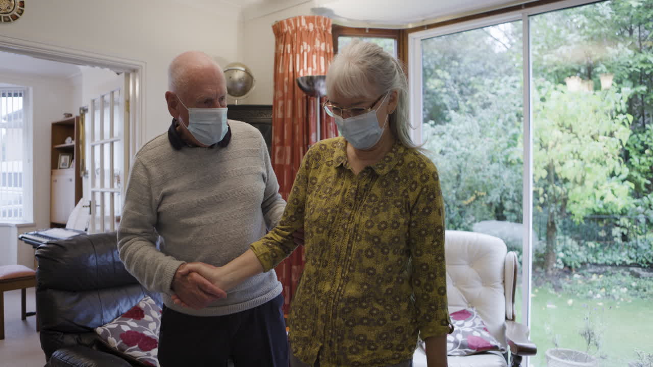 Elderly couple wearing face masks indoors