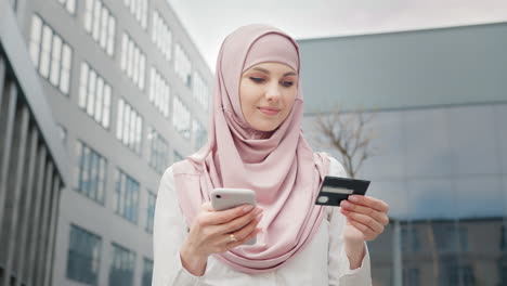 woman using mobile phone and credit card