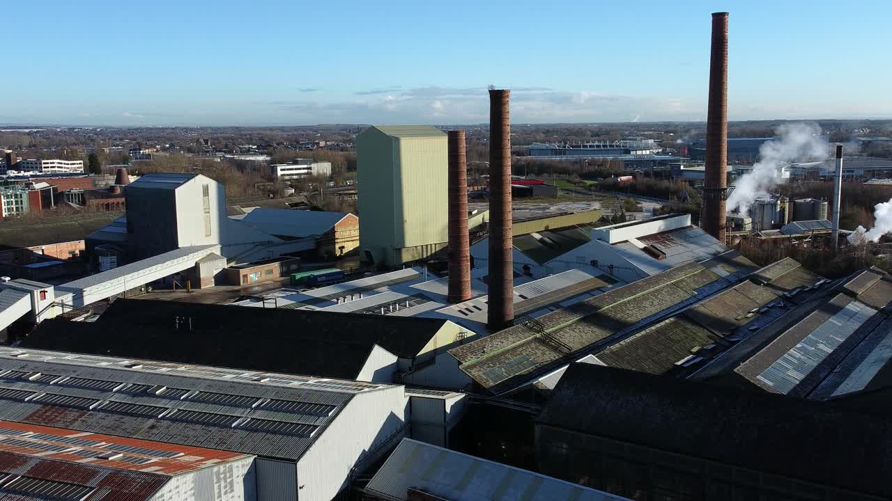 Pilkington glass factory warehouse buildings aerial view industrial town manufacturing facility, zooming in shot