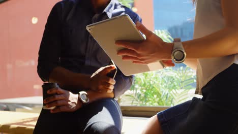 Mid-section-of-young-cool-business-team-planning-and-sitting-on-window-sill-of-modern-office-4k