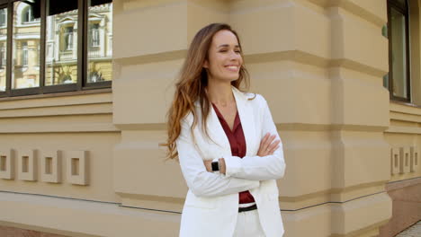 joyful executive woman smiling at city street