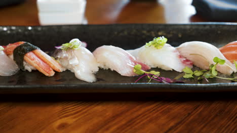 colorful unique line of traditional nigiri on elegant sushi platter, slider 4k