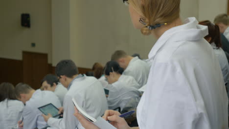 girl medical student makes notes on the lecture