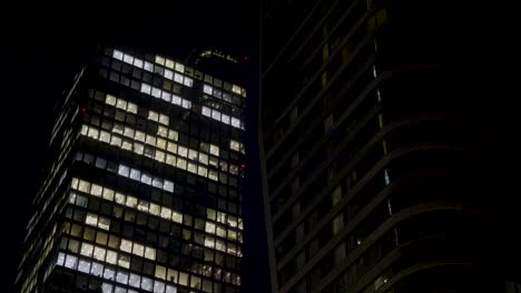 view of illuminated office windows in frankfurt skyscrapers at night with a modern feel