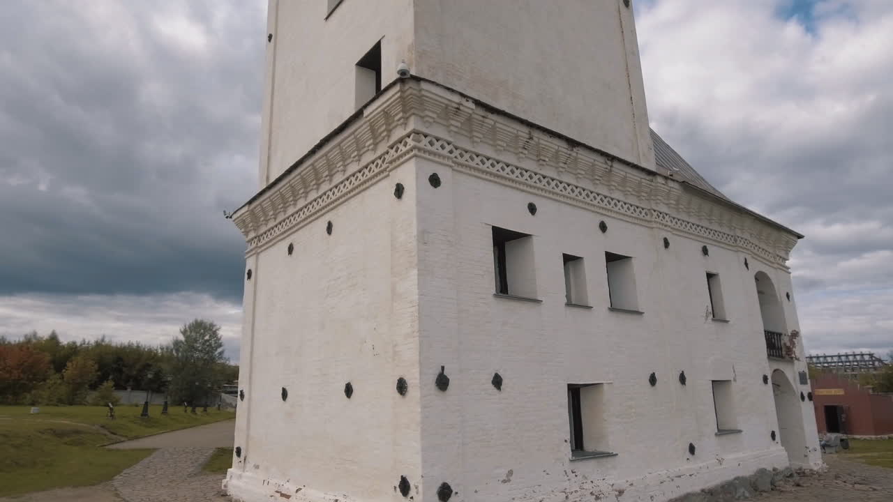 Old White Building with Tower and Cloudy Sky