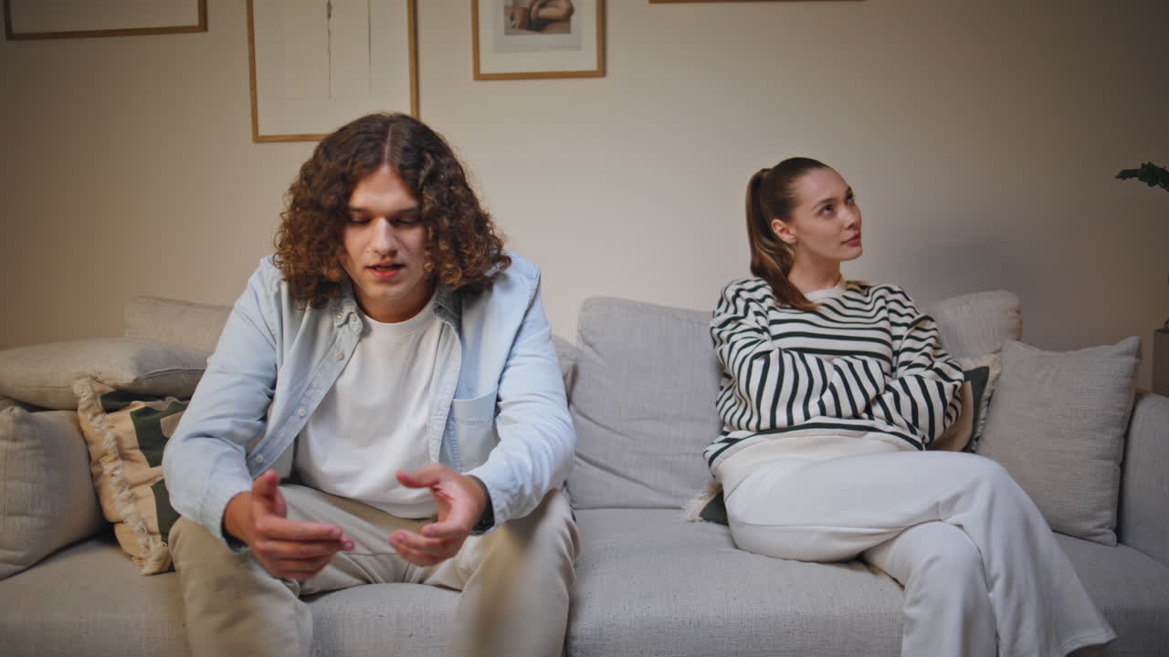 Frustrated couple arguing couch living room closeup. Offended woman separately