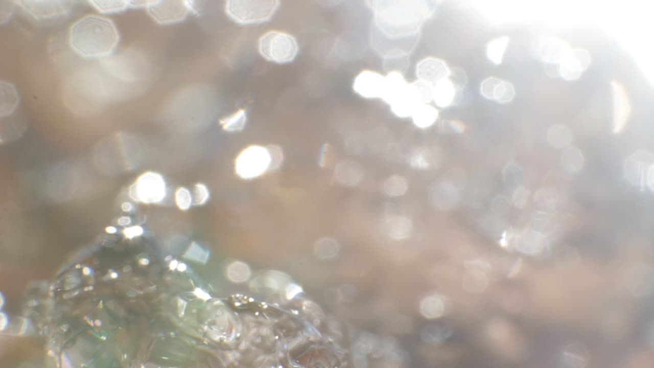 Macro of a piece of ice melting on the spring sun changing state